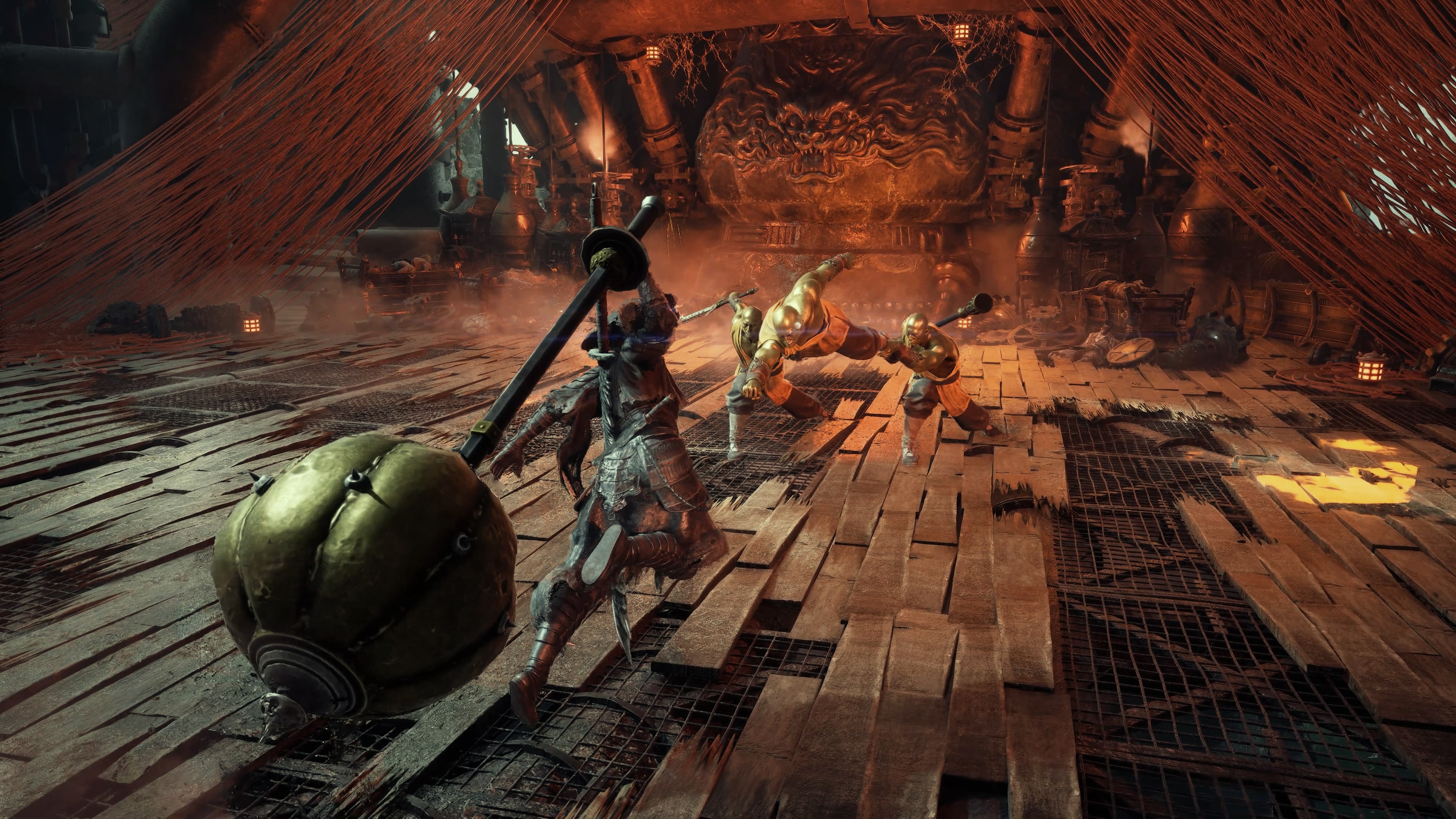 Official Phantom Blade Zero screenshot: a character carrying a long weapon on their back stands in a fire-lit, ruined hall facing two enemies, with a giant mask relief and crisscrossing ropes in the background